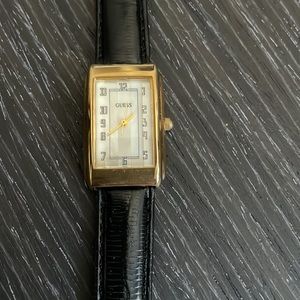 Guess watch. Mother of pearl face. Black band. Never been worn. Needs battery